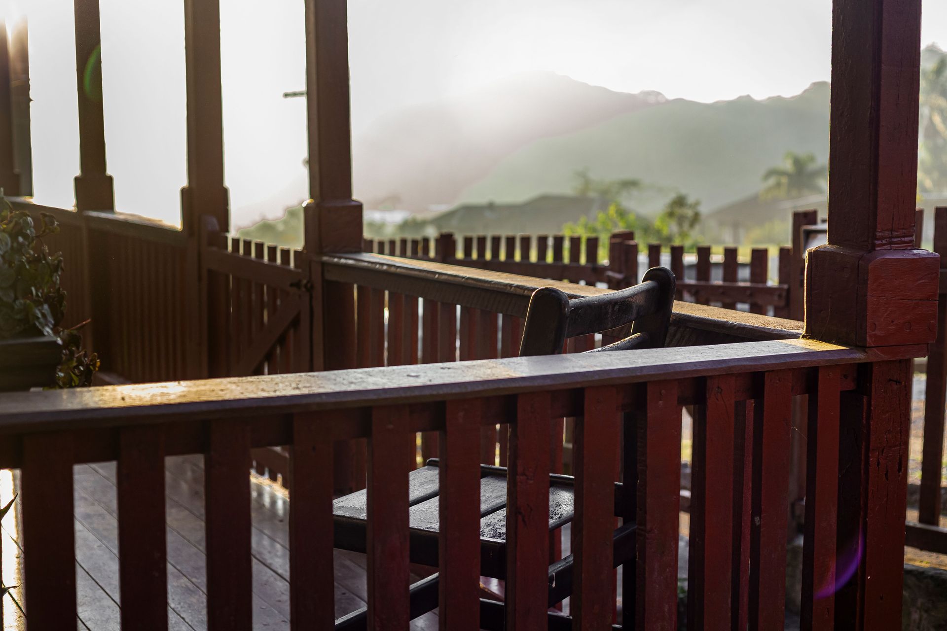 Peaceful morning light on a traditional wooden porch with mountain views.